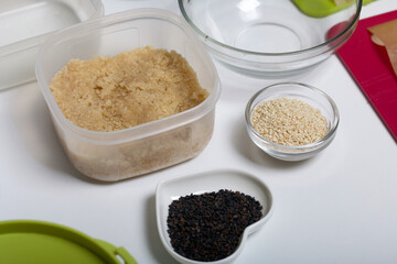 Dried fruit and nut sweets. The ingredients and tools for cooking are spread out on the table. Cooking sweets at home in isolation during an epidemic.