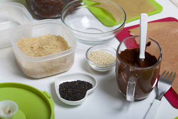 Dried fruit and nut sweets. The ingredients and tools for cooking are spread out on the table. Cooking sweets at home in isolation during an epidemic.