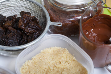 Dried fruit and nut sweets. The ingredients and tools for cooking are spread out on the table. Cooking sweets at home in isolation during an epidemic.