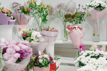 Flower shop concept. Close-up beautiful lovely bouquet of mixed flowers on wooden table.
