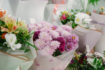 Flower shop concept. Close-up beautiful lovely bouquet of mixed flowers on wooden table.