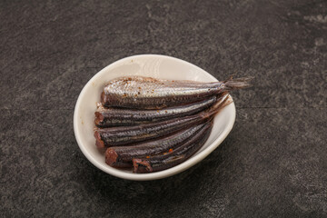 Anchovies in the bowl served basil leaves