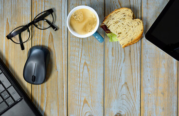 Working and eating lunch at home office on a laptop computer