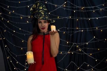 Caucasian woman wearing witch costume in Halloween festival party with black background and light