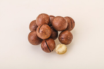 Brown macadamia nut heap over background