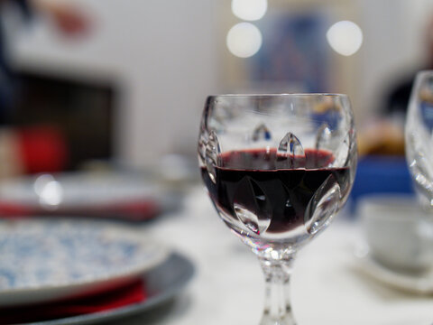 Birthday party at home with friends and family. An Italian red wine from the Tuscany region served in a crystal glass.