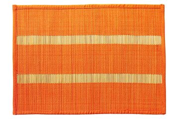 Orange braided bamboo food mat taken closeup isolated on white background.