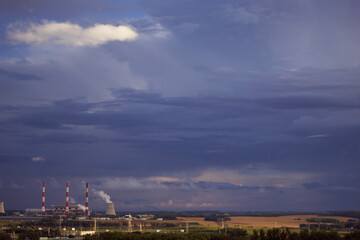 Fototapeta na wymiar city industrial pipes with smog and dark sky 