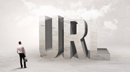 Rear view of a businessman standing in front of URL abbreviation, attention making concept