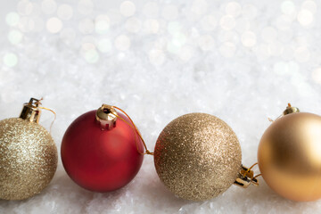 Gold, shiny and red balls for a New Year Christmas tree on a white background with space for text. Layout of a postcard, poster.