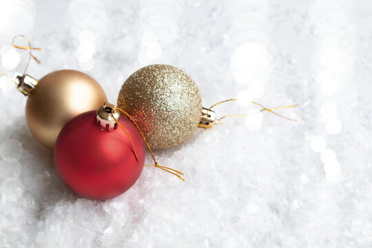 Gold, shiny and red balls for a New Year Christmas tree on a white background with space for text. Layout of a postcard, poster.