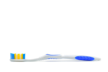 Toothbrush with colored bristles on a white background