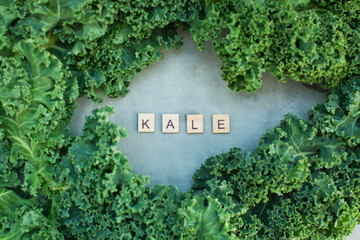 Green kale salad and wooden letters
