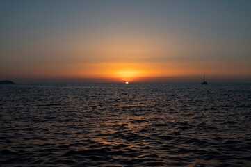 Fototapeta premium ship crosses the sea in the sunset
