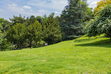 Fototapeta na wymiar Buttes-Chaumont Park (Parc des Buttes-Chaumont, 1867) - Public Park situated in northeastern Paris. Buttes-Chaumont Park - fifth-largest park in Paris. France.