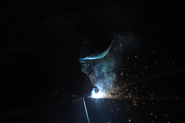 Welder assembling technical steel. Industrial welding of metal structures