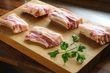 Raw pork ribs are cut into portions ready to cook. Natural light. Selective focus