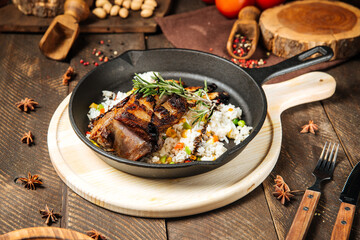 Mutton ribs with vegetables rice in cast iron pan