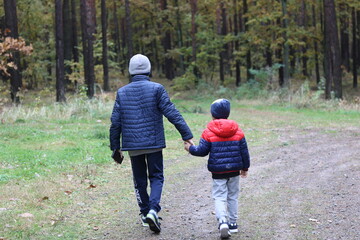 
Two little boys on a walk in the woods.