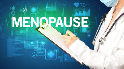 young doctor writing down notes with MENOPAUSE inscription, healthcare concept