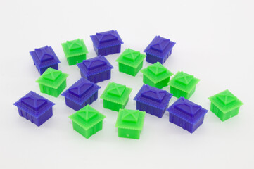 Green and blue house-shaped pieces for board games