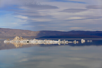Mono Lake Tufa State Natural Reserve, California. Spectacular panoramic view with beautiful clouds and white tufa rocks in water.