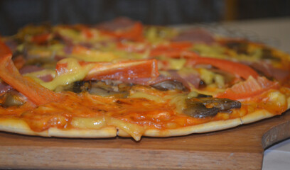 Homemade pizza with tomatoes, sauce, mayonnaise, pepper, cheese, mushrooms.