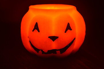 Festive orange candle pumpkin at night in the hands. Magic. Shine. Halloween. postcard, headband.