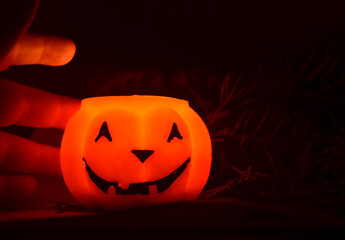Festive orange candle pumpkin at night in the hands. Magic. Shine. Halloween. postcard, headband.
