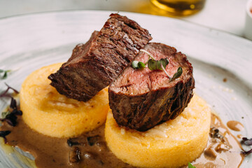 Beef medallion on corn porridge with sauce