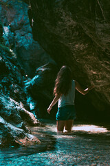 Young brunette woman discovering a steep rocky river canyon  in Slovenia