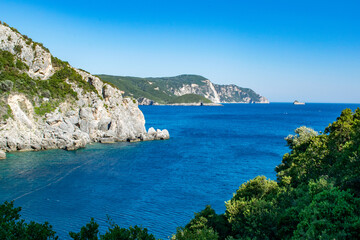 Fototapeta na wymiar A view of the Ionian Sea and surrounding limestone cliffs in Palaiokastritsa, Corfu, Greece