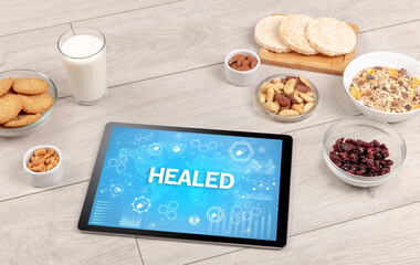 Healthy Tablet Pc compostion with HEALED inscription, immune system boost concept