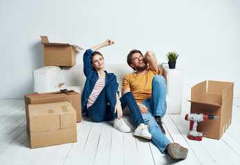 Men and women in a new apartment moving repair work boxes stuff