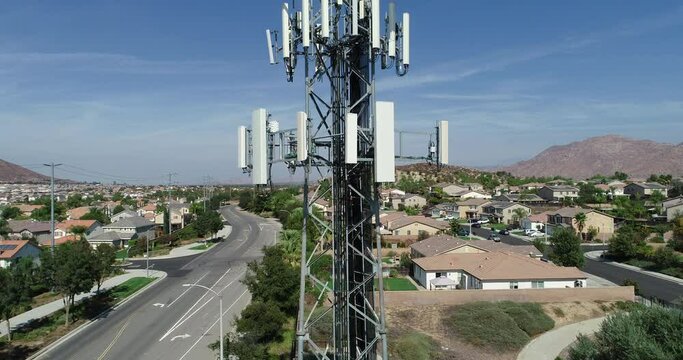 4K Close-up Aerial Crane of Cellular Wireless Mobile Data Tower with Neighborhood Surrounding.