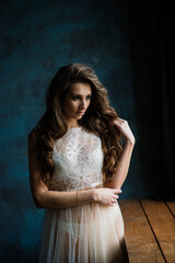 Portrait of a beautiful young female in a white underwear.