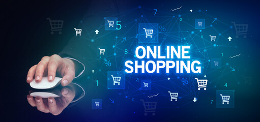 hand holding wireless peripheral with ONLINE SHOPPING inscription, online shopping concept