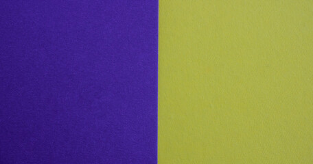 Purple-yellow background of matte suede, close-up. Velvety texture