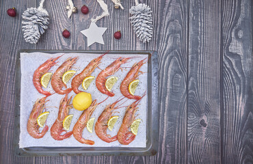 Red prawns with lemon, seafood for Christmas. Ready to eat. Menu, views of seafood. Giant shrimp cooked on a grainy white background