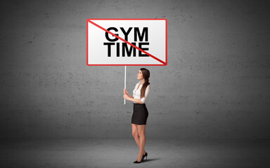 business person holding a traffic sign with GYM TIME inscription, new idea concept