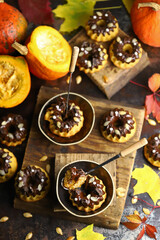 Selective focus. Pumpkin cupcakes with chocolate. Autumn desserts. Autumn still life with delicious pumpkin muffins.