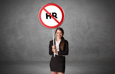 Young business person holdig traffic sign with HR abbreviation, technology solution concept