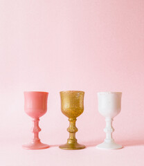 Creative spring concept made  three colorful variation  glasses   on pink pastel minimal  background  side view