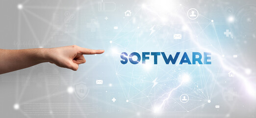 Hand pointing at SOFTWARE inscription, modern technology concept