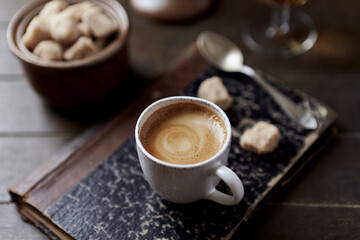 Cup of coffee on rustic wooden background. Close up. 