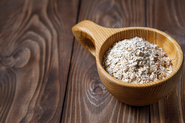 Wooden Cup with oatmeal. Health food. Wood texture