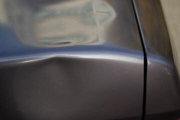 Dent on the car. Deformation of the car body.