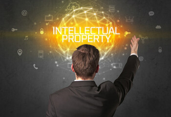 Rear view of a businessman with INTELLECTUAL PROPERTY inscription, online security concept