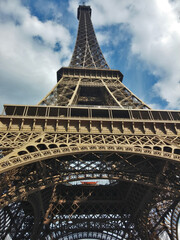 the Eiffel tower from the bottom with cloudy sky