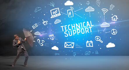 Businessman defending with umbrella from TECHNICAL SUPPORT inscription, modern technology concept